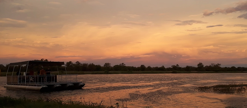 Sundowner boat cruise across golden waters with guests aboard