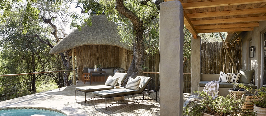 Private deck of the Londolozi Founders Camp family suite with plunge pool, sun loungers, and shaded seating area.