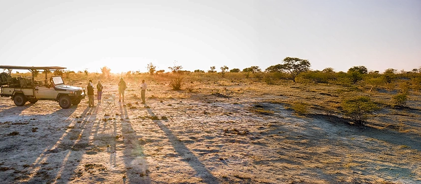 Safari vehicle and guests enjoying golden hour near Mankwe Tented Retreat