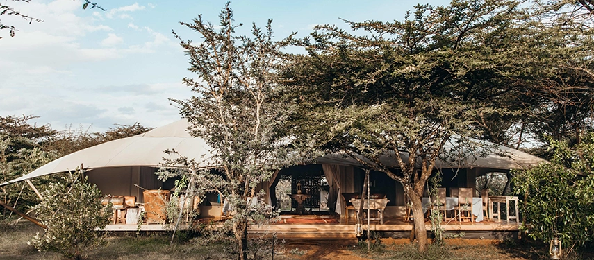 Open-sided communal lounge at Mara Expedition Camp in Kenya, designed for relaxed evenings and wildlife viewing in the heart of the Maasai Mara.