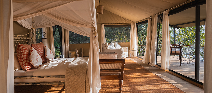Light-filled tented suite with large windows, comfortable seating, and river-facing veranda at Serian ‘The Original’.