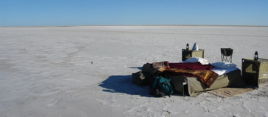 A private sleep-out is arranged on the vast Makgadikgadi salt pans, offering an unforgettable night beneath open desert skies.