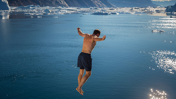 Man leaping into the Antarctic ocean