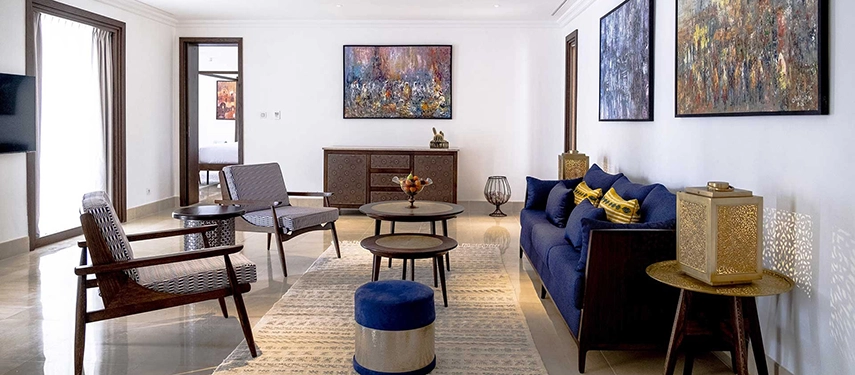 Spacious interior of the Royal Oasis Villa at The Residence Douz with modern furnishings and artwork.
