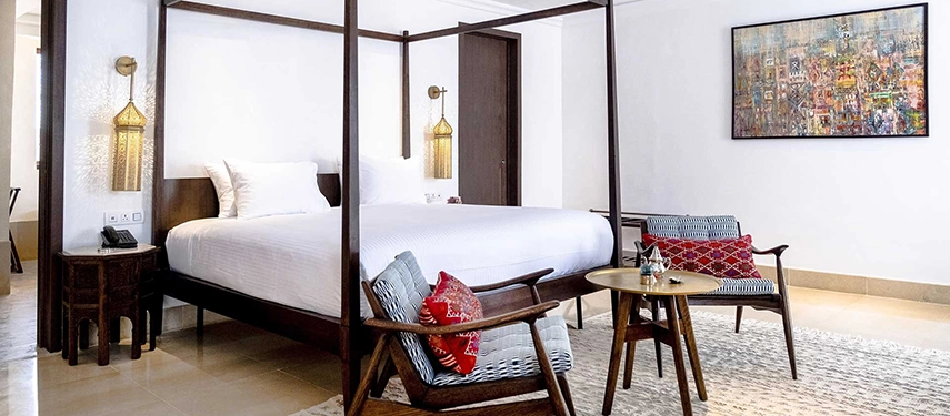 Luxury guest room at The Residence Douz with a four-poster bed, lantern lighting, and modern decor.