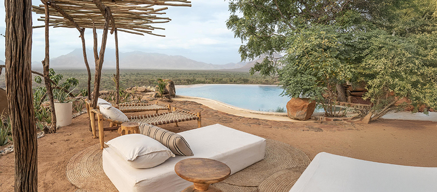 Shaded outdoor lounge beds overlooking the infinity pool and Samburu plains at Reteti House.
