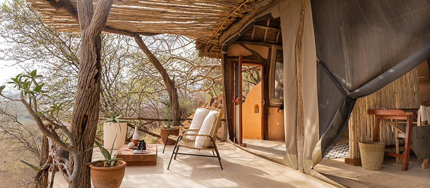 Private shaded veranda with armchair seating and bush views at Reteti House guest suite.