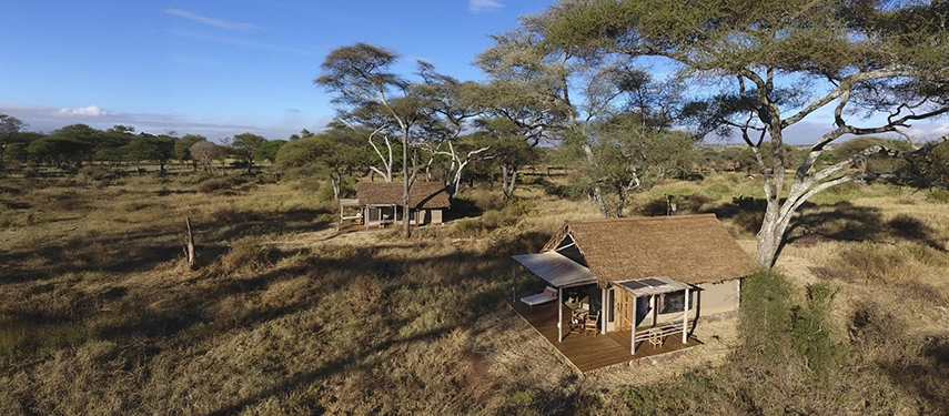 Canvas safari rooms are spaced discreetly across open grassland, offering privacy, shade and uninterrupted views of Tarangire.