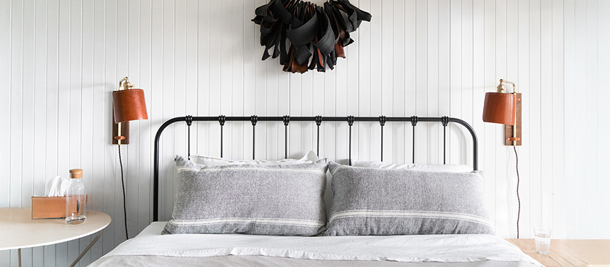 King bed with elegant, minimalist styling in a guest suite