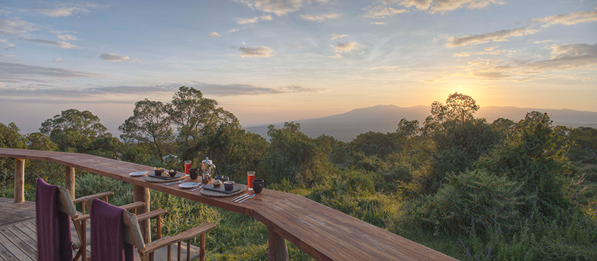 Private breakfast setup for two overlooking the Ngorongoro highlands at sunrise