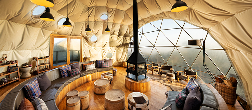 The Highlands’ main dome lounge with floor-to-ceiling windows and central fireplace