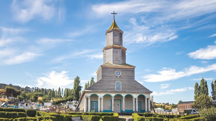 The iconic wooden church of Chonchi set against a bright blue sky