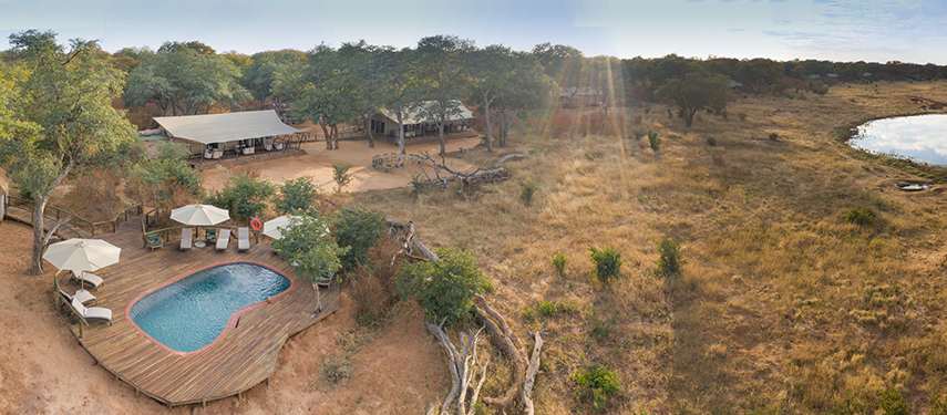 Elevated aerial view of Verney’s Camp showing the swimming pool area, tented suites and surrounding bushveld.