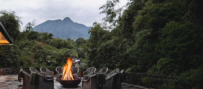 Boma and campfire overlooking the Virunga Mountains at dusk in Rwanda