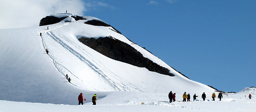 Tourists hike to a remote hilltop in Antarctica