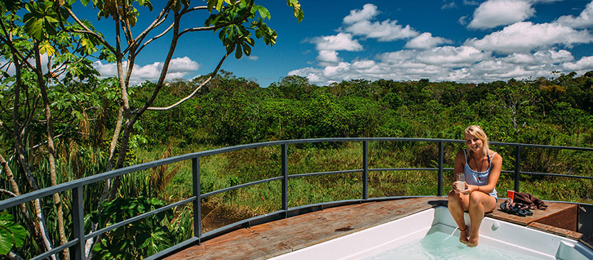Woman sitting on the edge of a jacuzzi aboard the Aqua Nera luxury cruise on the Amazon River in Peru