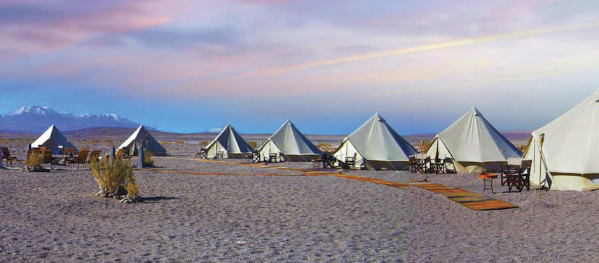 A collection of luxury glamping tents on the plains of Chile's Atacama Desert