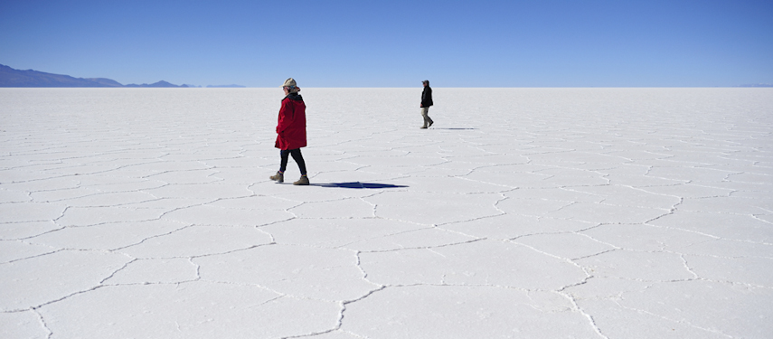 Tourists walking on the salt pans of the Atacama Desert