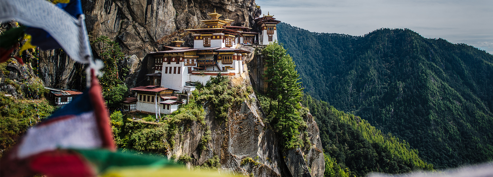 Bhutan's incredible Tiger's Nest Monastery with prayer flags in the foreground.