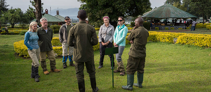 Group of tourists receive a briefing from their guide before going gorilla trekking in Rwanda