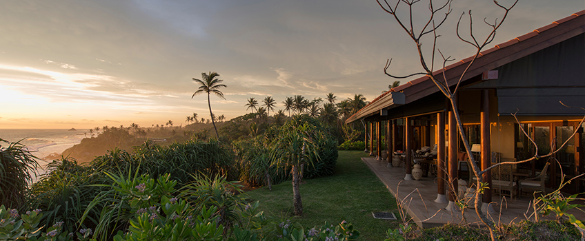 Luxury villa overlooking the coastline at sunset
