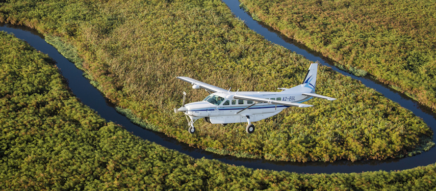 Fly over floodplains and dense woodland to Vumbura Plains