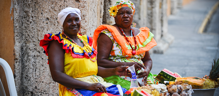 Fruit sellers in vibrant clothing on a street in Columbia