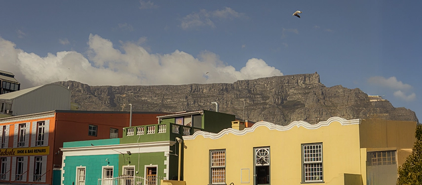 Colourful street scene of Bo Kaap, South Africa, with Table Mountain in the background