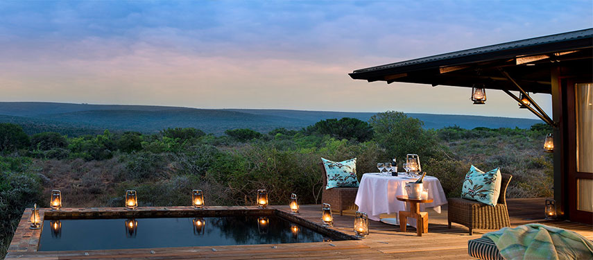 Private dining by the pool with panoramic views of the Kwandwe Reserve at Ecca Lodge