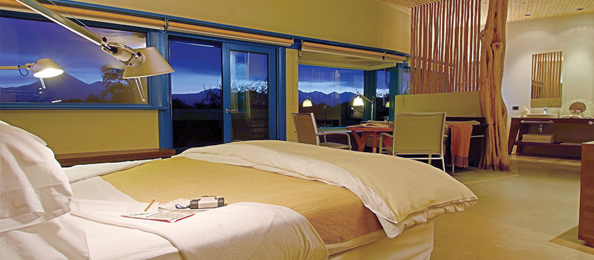 Luxurious double suite with sunset views to distant mountains at Explora Atacama, Chile