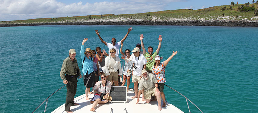 Passengers celebrate on deck of a cruise boat in the Galápagos Islands