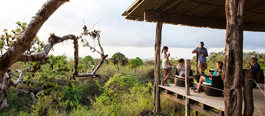 Family on the balcony of Galápagos Safari Camp enjoying drinks and a snack