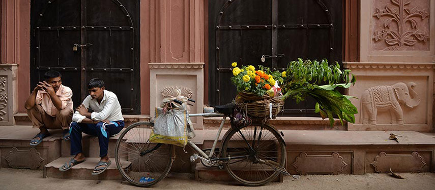 Two men sit outside Haveli Dharampura, India
