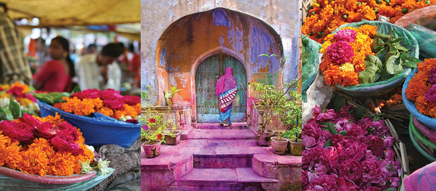 A vibrant Indian market filled with flowers and colourful paint and chalk