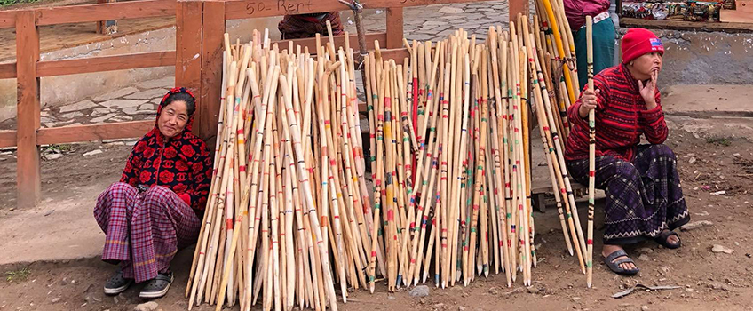 Women selling hiking poles at the head of the trail to Tiger's Nest