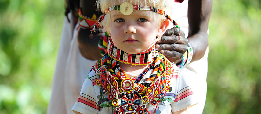 Child dressed up and interacting with Samburu guides at Karisia's Walking Safaris