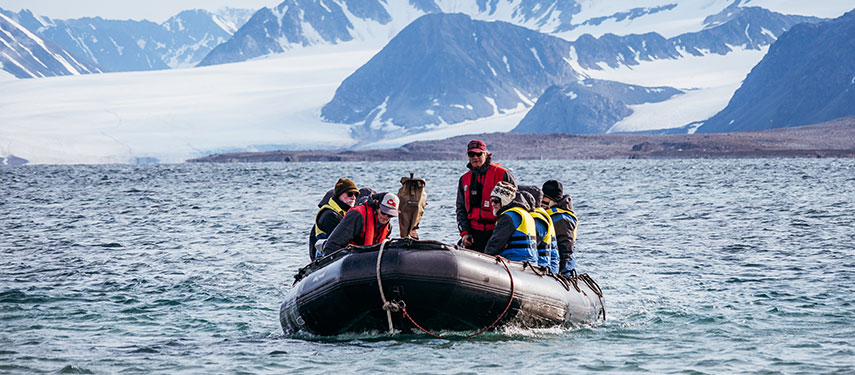 Group of tourists cross a fjord in Norway in a zodiac