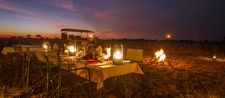 Intimate bush dinner as the sun sets at Kwando Lagoon in Botswana