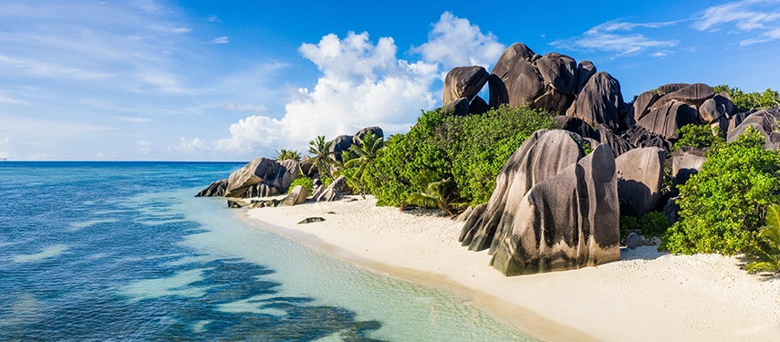 Granite boulders and turquoise lagoon along La Digue’s famous Anse Source d’Argent beach.