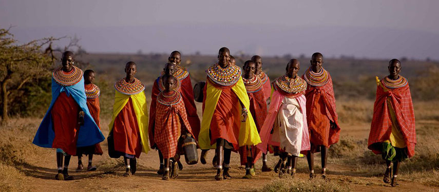 A gathering of Maasai ladies in Kenya, all wearing colourful textiles