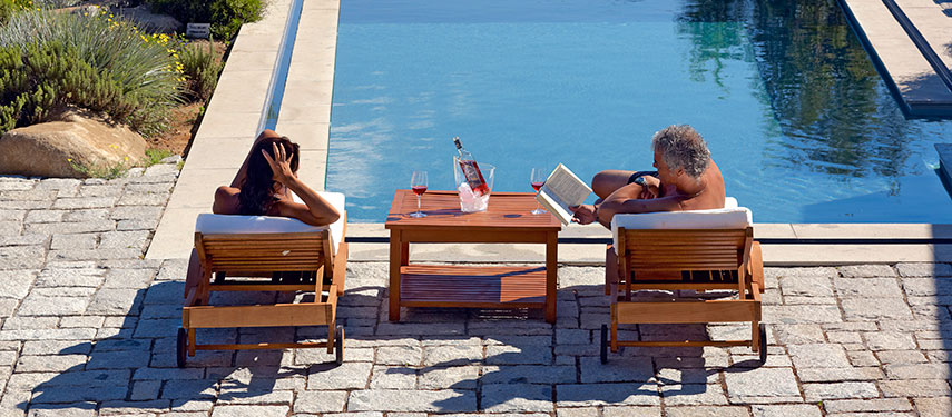 Couple relax by a pool at Clos Apalta Residence in Chile's wine region.