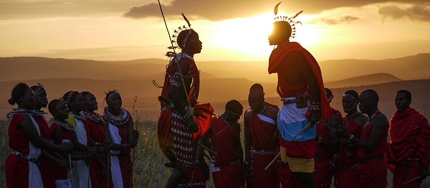Samburu tribesmen in traditional dress at sunset. Lewa House, Kenya.