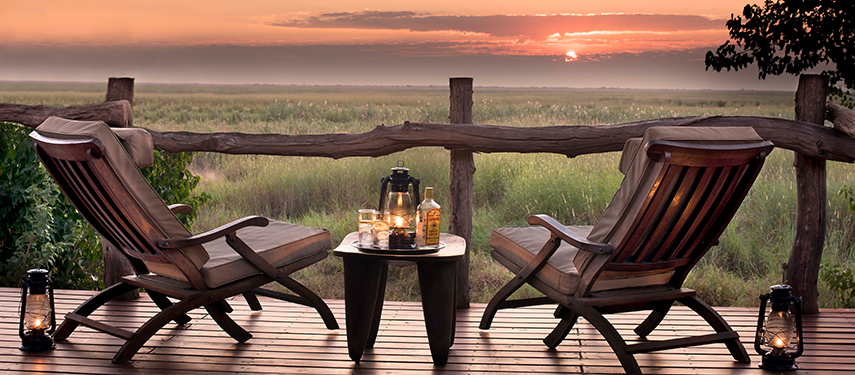 Relax with sundowners looking over the marshes at Linyanti Bush camp