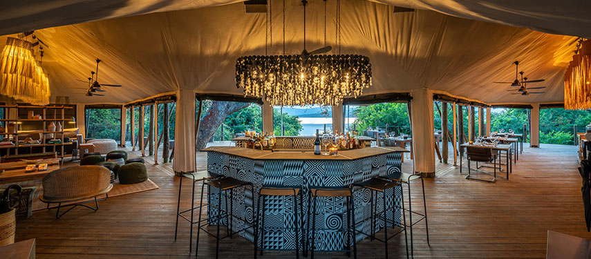The bar at Magashi safari camp, with warm, golden lighting
