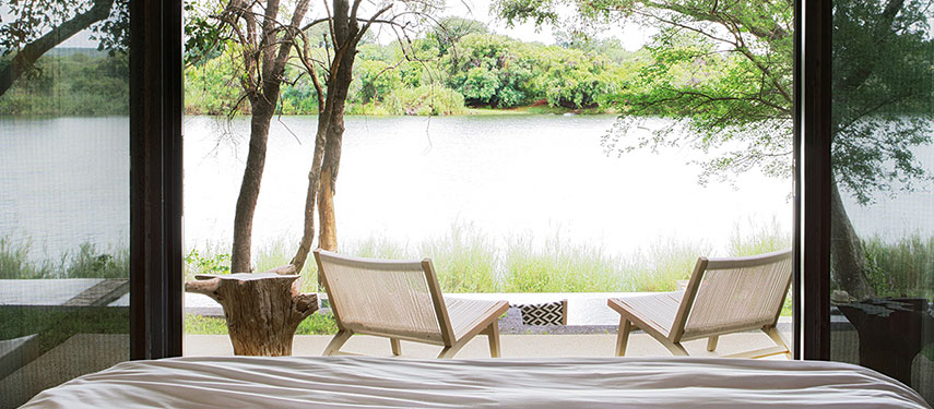 Suites at Matetsi River Lodge invite you to relax and enjoy views of the river on your private deck