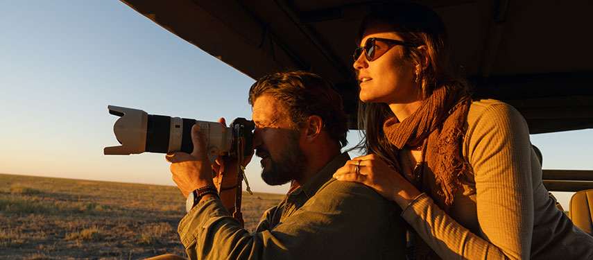 Couple taking photographs while on safari in Botswana
