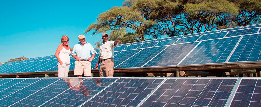 Tourists viewing renewable energy solar facility on a sustainable African safari