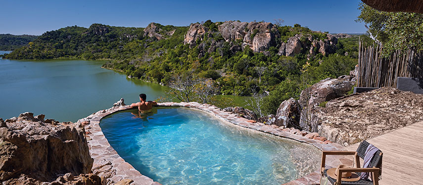 From the pool look out for birds and wildlife in the Malilangwe lake at Singita Pamushana