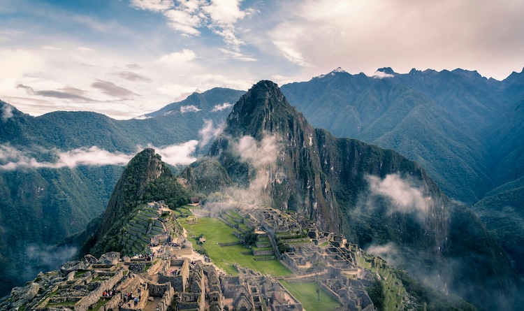 Machu Picchu in the early morning, with mist across the mountain and ruins
