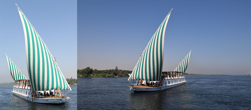 A traditional dahabeya boat sailing on the Nile River in Egypt.